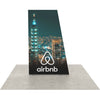 Center view of 5ft Angled Firefly Lightbox with even backlighting and sleek angled frame, displaying a vibrant city skyline for booth or retail use.