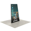Side view of 5ft Angled Firefly Lightbox featuring a night cityscape with illuminated buildings, positioned on light grey flooring for exhibit presentation.