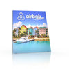 8ft Angled Firefly Lightbox display featuring a backlit graphic of colourful seaside homes and a white yacht on reflective flooring, ideal for trade show visibility.
