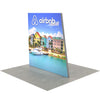 Right-side perspective of 8ft Angled Firefly Lightbox highlighting slim frame depth, bright edge lighting, and scenic coastal backdrop for display environments.