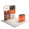 Three quarter booth view featuring a curved tension fabric backdrop with mounted lights and branded counter.