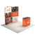 Three quarter booth view featuring a curved tension fabric backdrop with mounted lights and branded counter.