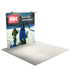 Three quarter view of a straight tension fabric backdrop with top mounted LED lights in a booth setting.