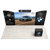 Full-width front perspective capturing the complete 20ft exhibit footprint with illuminated graphics, overhead branding, angled wing panels, and podium positioned at the front.