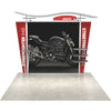 Front view of the 10ft Timberline Heavy Duty trade show booth featuring a tension-fabric backdrop, wing panels, and curved canopy on a sample floor surface